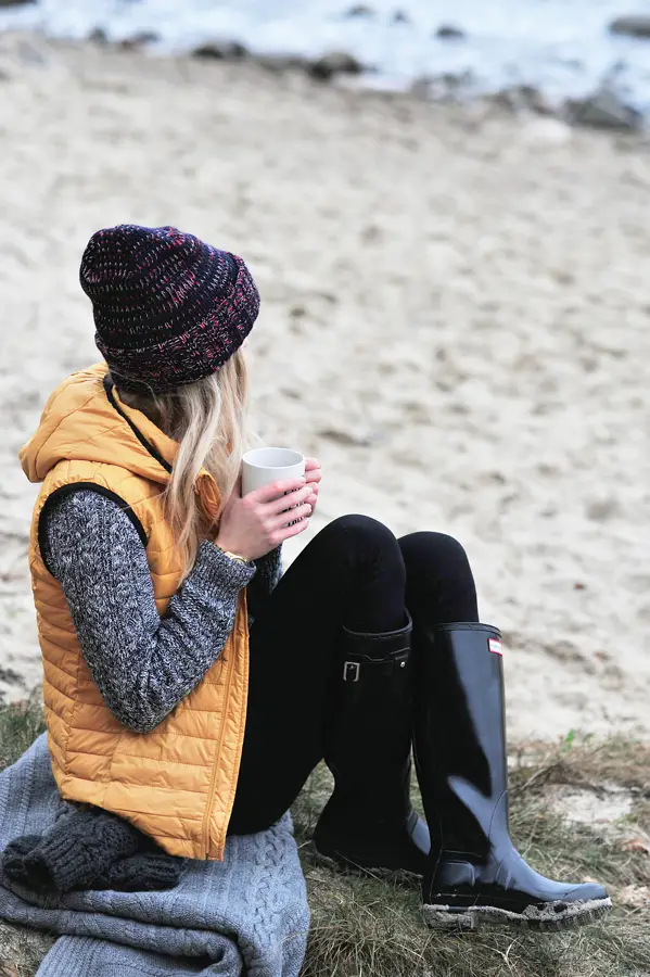 On the beach wearing rain boots  . Black rain boots outfits