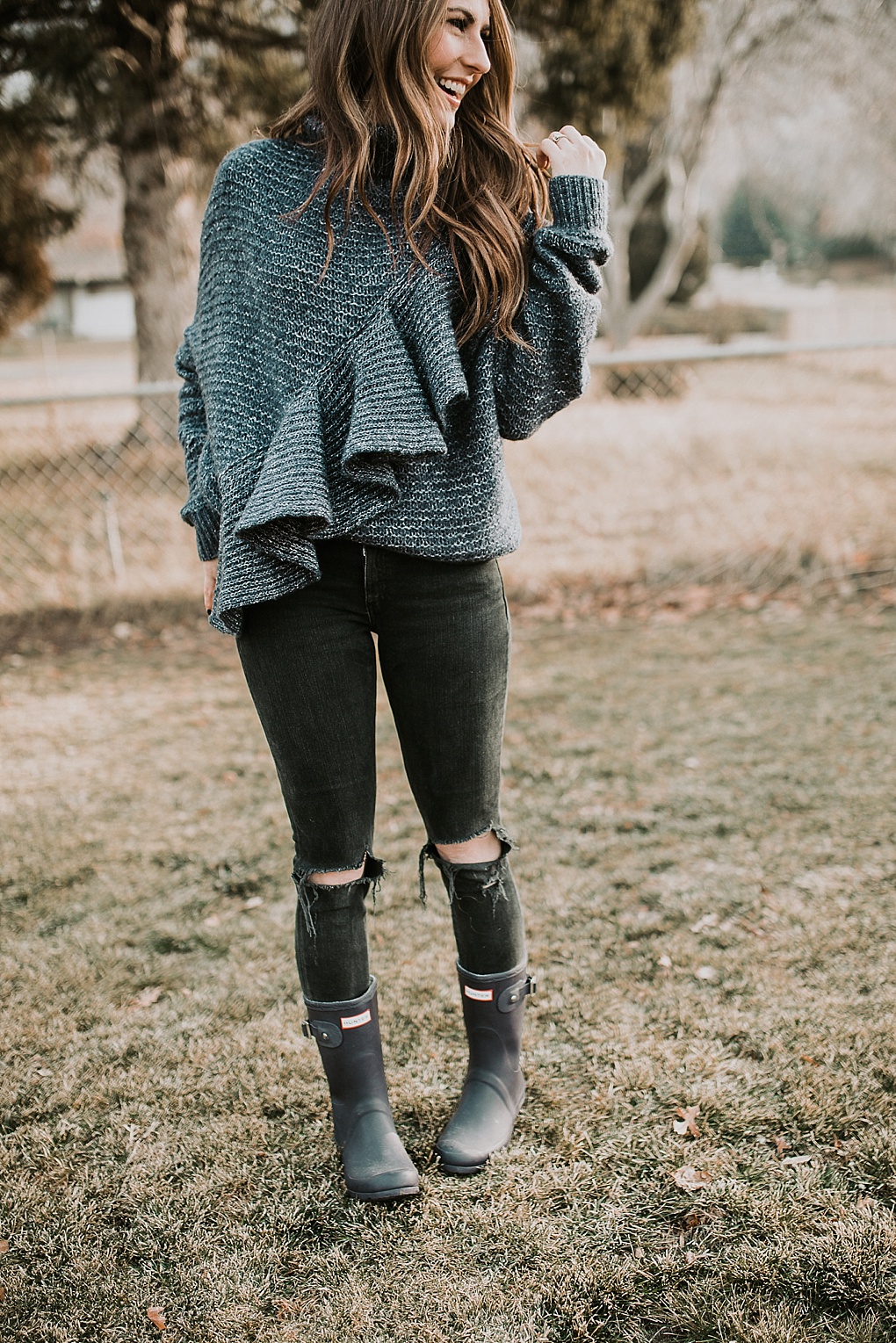 Short black rain boots with jeans