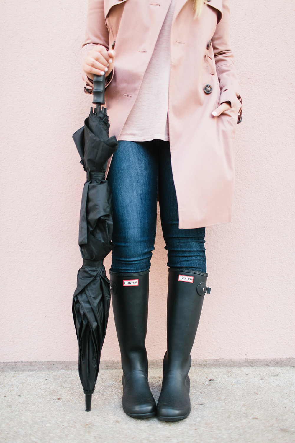 Pink trench coat with tall black rain boots